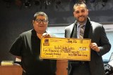 Tachi Palace General Manager Willie Barrios presents a check to Development Manager Pedro Santana of United Health Centers Foundation.